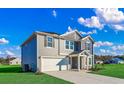 Two-story home with gray siding, white garage door, and landscaped yard at 1049 Kinness Dr., Conway, SC 29527