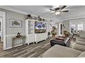 Bright living room featuring hardwood floors, comfortable seating, and a large TV at 407 15Th Ave. S, North Myrtle Beach, SC 29582