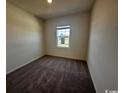 Bright bedroom with carpet flooring and a large window at 147 Linares St., Loris, SC 29569