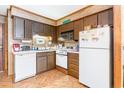 Galley kitchen with white appliances and wood cabinets at 1582 S Waccamaw Dr. # 60, Garden City Beach, SC 29576