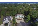Aerial view of a teal home with ocean views and surrounding properties at 119 Cockle Shell Ct., Pawleys Island, SC 29585