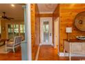Hallway with wood walls, hardwood floors, and access to other rooms at 119 Cockle Shell Ct., Pawleys Island, SC 29585
