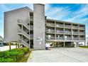 Three-story building with parking and balconies at 120 North Dogwood Dr. # 113, Garden City Beach, SC 29576
