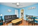 Bright living room with comfy seating, wood floors, and a kitchenette at 120 North Dogwood Dr. # 113, Garden City Beach, SC 29576