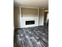 Living room featuring a built-in electric fireplace and gray wood-look flooring at 8750 W Highway 19, Loris, SC 29569