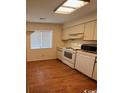 Efficient kitchen with white appliances and wood floors at 1210 Pinegrove Dr. # G, Myrtle Beach, SC 29577