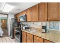 Fully equipped kitchen with granite countertops and modern appliances at 200 76Th Ave. N # 1106, Myrtle Beach, SC 29572
