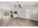 Open floor plan living room, kitchen, and dining area with vinyl plank flooring at 326 Barn Owl Way, Conway, SC 29527