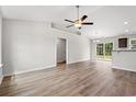 Open living room and kitchen with vinyl plank floors and a view of the backyard at 326 Barn Owl Way, Conway, SC 29527