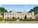 Three-story townhome building with a tan exterior and landscaping at 4541 Girvan Dr. # 27-D, Myrtle Beach, SC 29579