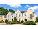 Three-story townhome building with a tan exterior and landscaping at 4541 Girvan Dr. # 27-D, Myrtle Beach, SC 29579