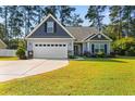 Charming one-story home with a two-car garage and landscaped lawn at 2105 Cultra Rd., Conway, SC 29526