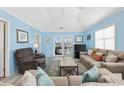 Light and airy living room with light blue walls and comfortable seating at 405 N 30Th Ave. N, North Myrtle Beach, SC 29582