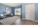 Cozy living room with blue walls, hardwood floors, and two armchairs at 5700 Redgum Dr., Myrtle Beach, SC 29579