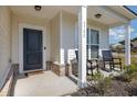 Inviting front porch with rocking chairs and landscaping at 5700 Redgum Dr., Myrtle Beach, SC 29579