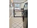 Cozy kitchen with white cabinets, black appliances, and tile flooring at 1025 Carolina Rd. # F2, Conway, SC 29526