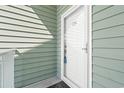 Exterior view of a building entrance with a green door at 84 S Addison Cottage Way # 213, Murrells Inlet, SC 29576