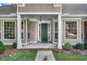 Inviting front entrance with a green door and a covered porch at 4551 Painted Fern Ct. # 5, Murrells Inlet, SC 29576