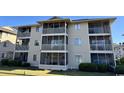Three-story building with screened balconies and landscaping at 4278 Pinehurst Circle # W2, Little River, SC 29566