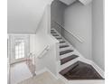 Modern staircase with dark wood steps and white risers at 7300 Porcher Dr. # 8, Myrtle Beach, SC 29572