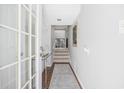 Bright entryway with tile flooring, glass door, and staircase leading upstairs at 7300 Porcher Dr. # 8, Myrtle Beach, SC 29572