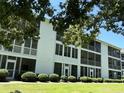 White building exterior with balconies and green lawn at 1525 Lantern Rest Dr. # 301, Myrtle Beach, SC 29579