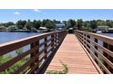 Wooden dock extending to the waterway with houses in the background at 1525 Lantern Rest Dr. # 301, Myrtle Beach, SC 29579