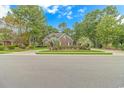 Brick home nestled among lush greenery and trees at 676 Oxbow Dr., Myrtle Beach, SC 29579