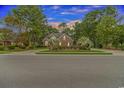 Brick home with a beautiful, tree-lined streetscape at 676 Oxbow Dr., Myrtle Beach, SC 29579