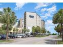 Oceanfront resort building with palm trees and parking at 200 76Th Ave. N # 411, Myrtle Beach, SC 29572