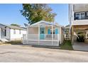 Charming cottage with a white exterior, blue shutters, and a porch at 6001 - 1749 S Kings Hwy., Myrtle Beach, SC 29575