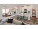 Open concept kitchen with island and white cabinets at 8605 Pinnacle Cove Way, Longs, SC 29568