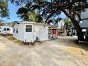 View of the back of a white cottage with a double door garage at 6001 - M26 S Kings Hwy., Myrtle Beach, SC 29575