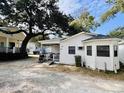 White cottage with a porch, grill and side yard at 6001 - M26 S Kings Hwy., Myrtle Beach, SC 29575
