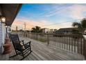 Deck with rocking chairs and street view at 3801 N Ocean Blvd., North Myrtle Beach, SC 29582