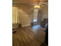 Living room with laminate flooring and a comfy armchair at 708 Grices Ferry Ct., Mullins, SC 29574
