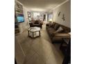 Spacious living room with ample seating and view into dining area at 311 69Th Ave. N # 104, Myrtle Beach, SC 29572