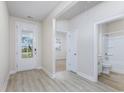 Light and bright entryway with vinyl flooring, leading to a bedroom and bathroom at 6041 Mcclain Ct., Little River, SC 29566