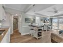 Open concept living room with kitchen, island, and access to a balcony at 14290 Ocean Hwy. # 202, Pawleys Island, SC 29585