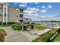 Community grilling area with marina view at 4220 Coquina Harbour Dr. # B-11, Little River, SC 29566