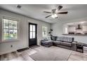 Open living room with L-shaped sectional sofa and hardwood floors at 829 44Th Ave. N, Myrtle Beach, SC 29577