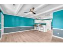 Open living and kitchen area with teal walls at 519 31St Ave. N # 7, Myrtle Beach, SC 29577