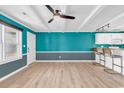 Open living and kitchen area with teal walls at 519 31St Ave. N # 7, Myrtle Beach, SC 29577