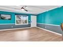 Living room with teal walls and light wood floors at 519 31St Ave. N # 7, Myrtle Beach, SC 29577