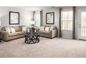 Living room with beige sofas, coffee table, and large windows at 1024 Oak Meadow Dr., Conway, SC 29526