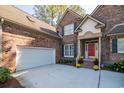 Brick home with a red door and attached garage at 1495 Hawthorn Dr., Pawleys Island, SC 29585