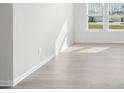 Sunlit living room with hardwood floors and white walls at 650 Blackthorne Circle Nw, Calabash, NC 28467