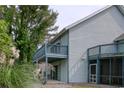 Side view of building highlighting balcony and landscaping at 4337 Spa Dr. # 1309, Little River, SC 29566
