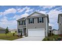 Two story house with gray siding and a two car garage at 4015 Smokey Dr, Conway, SC 29526