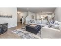 Bright living room features a spacious sectional sofa and an open floor plan at 3519 Cornflower Way, Conway, SC 29526